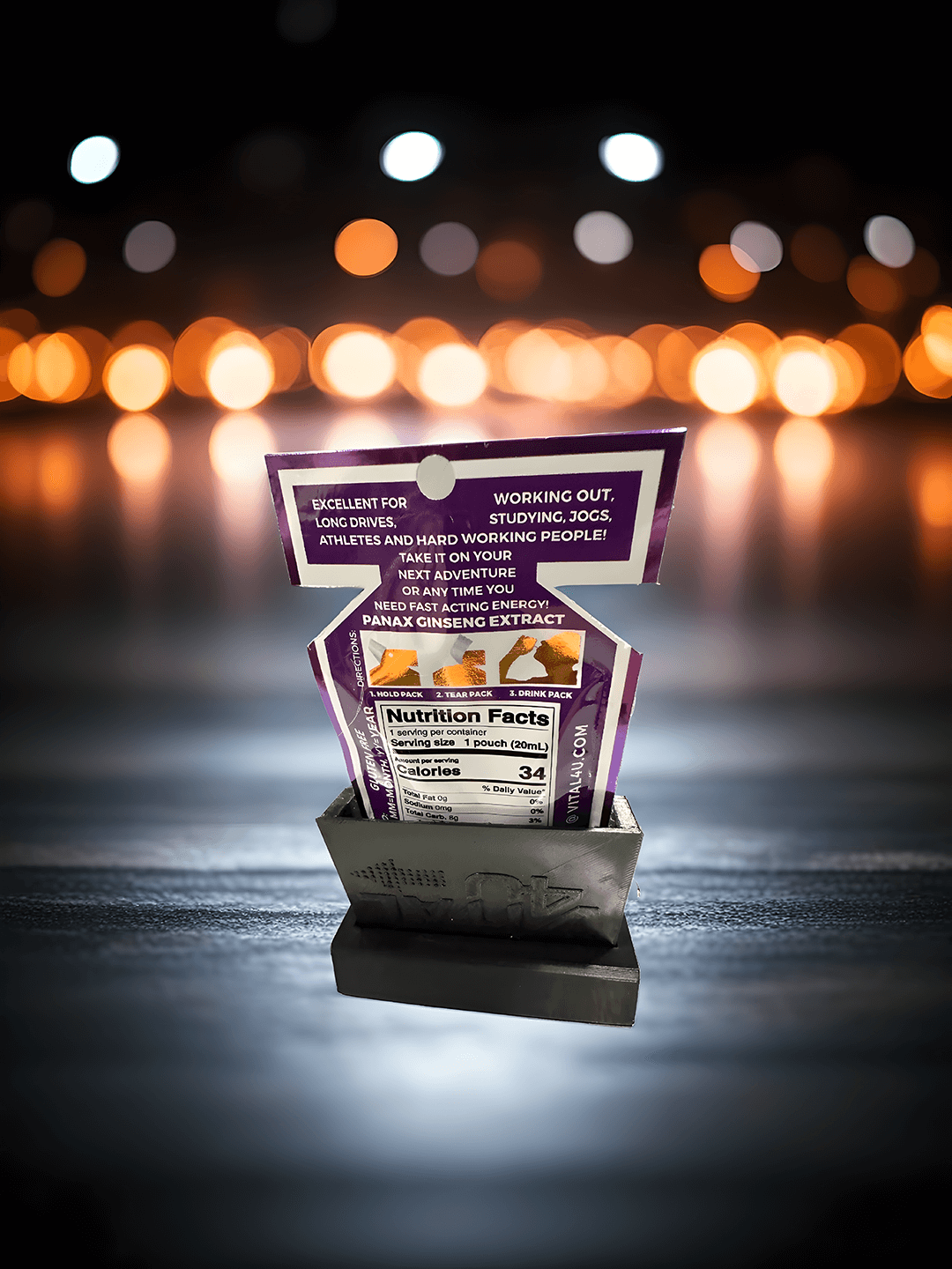 A wide shot of the back of the tropical flavored Screamin Energy Max liquid energy pouch with nutrition facts being held in the black Energy Dock.